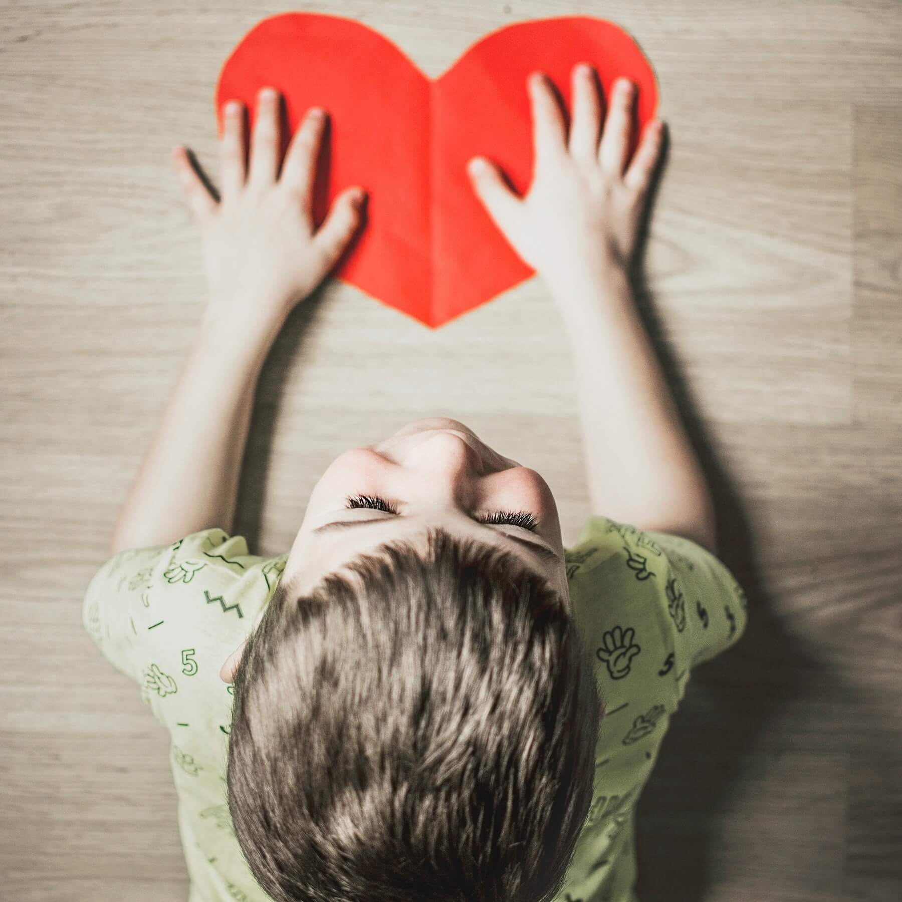 A child holding a paper heart