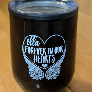 Black insulated tumbler with clear lid and white heart design reading Ella forever in our hearts above angel wings.